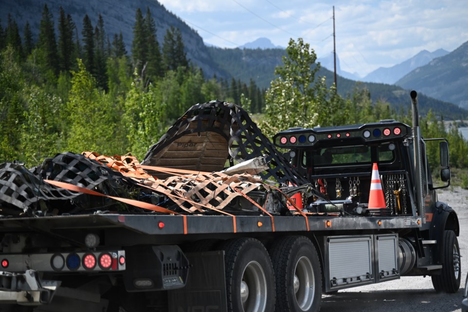 A flat bed truck hauls debris from a crashed airplane after an Alpine helicopter flew it out of the crash site near Kananaskis on July 29, 2023. MATTHEW THOMPSON RMO FILE PHOTO