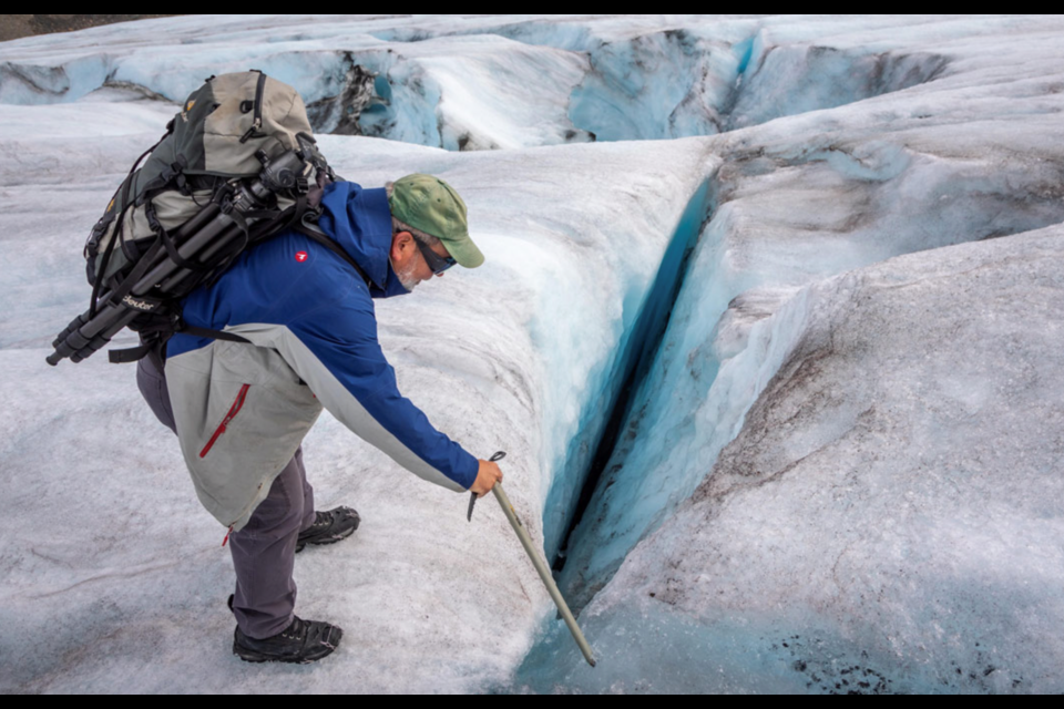 University of Saskatchewan water researcher John Pomeroy is pictured observing a crevasse on the Athabasca Glacier in the Canadian Rockies. Photo Sam Baardman