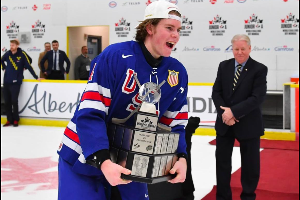 Smiling ear-to-ear, Finn McLaughlin carries the World Junior A Challenge trophy. ANDY DEVLIN HOCKEY CANADA PHOTO