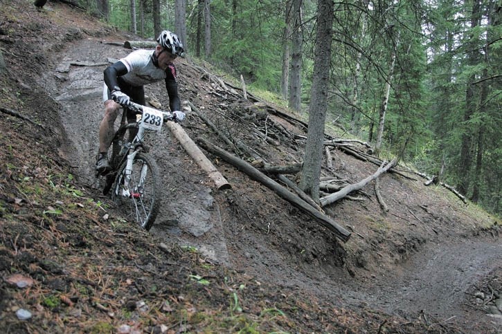 Canmore’s John Firth manoeuvres down the greasy section of trail called the Laundry Chutes en route to second in the expert category in Saturday’s (June 11) Iron Maiden