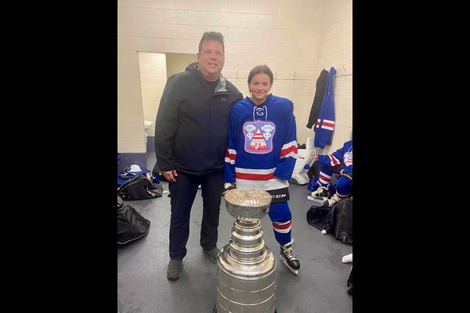 Jamie and Madison Maness share a photo with the Stanley Cup at the Little NHL Tournament in Markham, ON.
