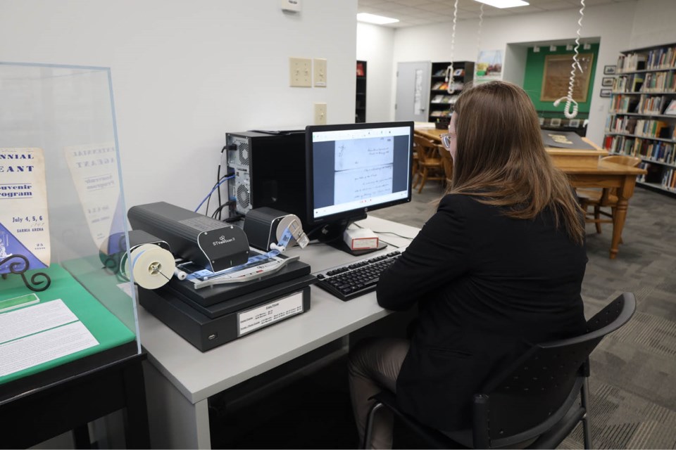 a-visitor-browses-a-moore-township-paper-on-microfilm-at-lambton-county-archives