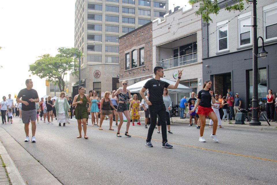 A group of participants follow Latin Fire’s dance instructor at Art in the Street, Sarnia.