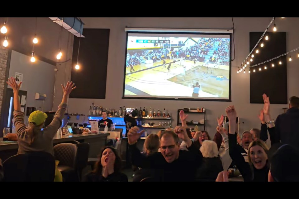 The crowd erupts at Imperial City Crew House, where the Lambton College women's basketball games were streamed live over the weekend. The Lions were playing for the CCAA national title.