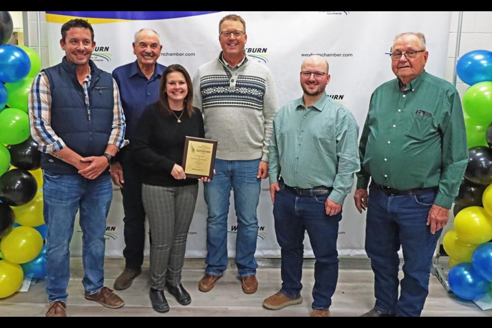 The families and staff of Axten Farms Ltd. gathered following the presentation of the Golden Sheaf Award on Tuesday night, by the Weyburn Chamber of Commerce. From left are Frederick Mybaugh, Lyle Hoimyr, Tannis and Derek Axten, Daniel Metheral and Herb Axten.