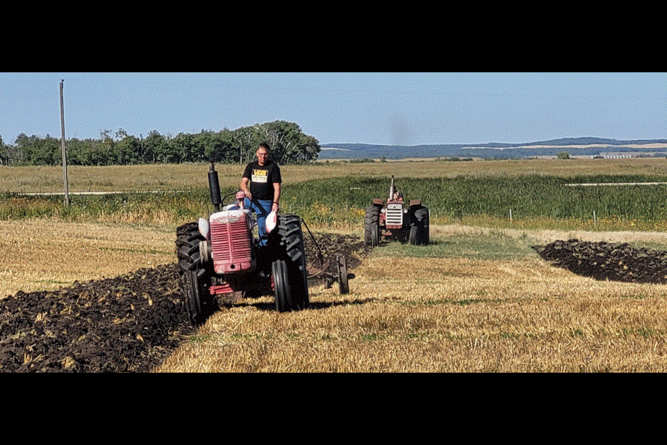 From left, Darryl Johnson drove a WD6 1948 International, while Colton Wilson drove a 1958 International while showing the crowd how plowing was done back in the day. 