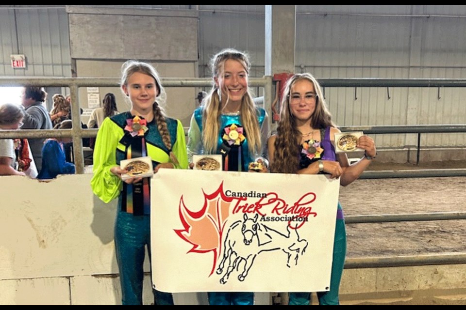 Truco riders Bailey Steeves, Jordanna White and Shayda King show the awards they won at the Canadian Trick Riders competition held in Ft. Macleod, Alta., on Aug. 22-23.