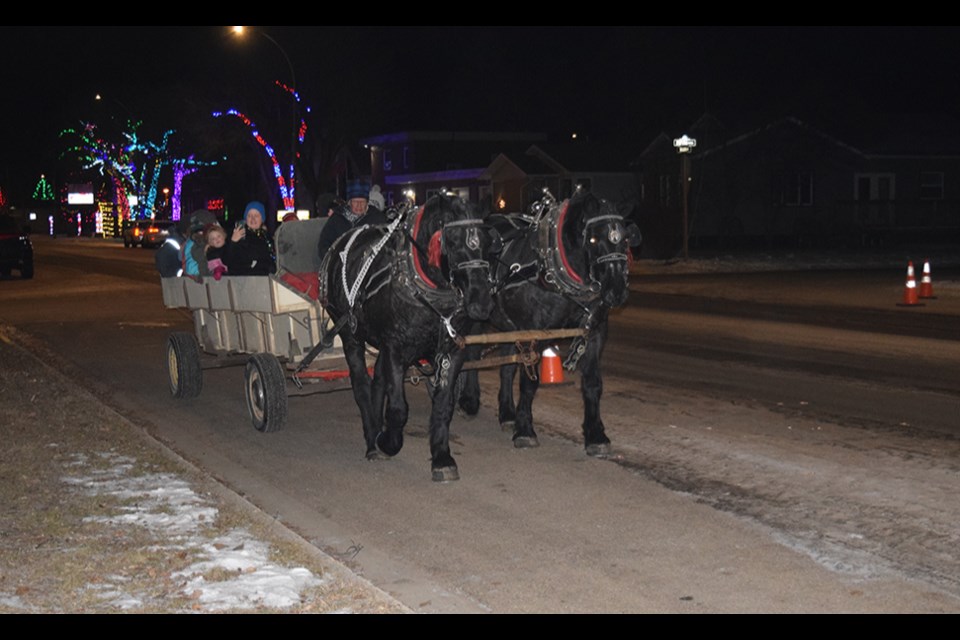 The lineups were long outside the Curling Rink on Dec. 5 as Canora and area residents of all ages anxiously awaited their turn for traditional horse-drawn wagon rides along the streets of Canora. 