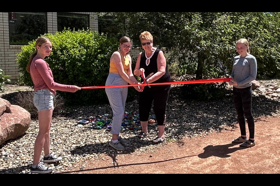 Students cut the ribbon with Mayor Schauenberg at the Rock Garden.
