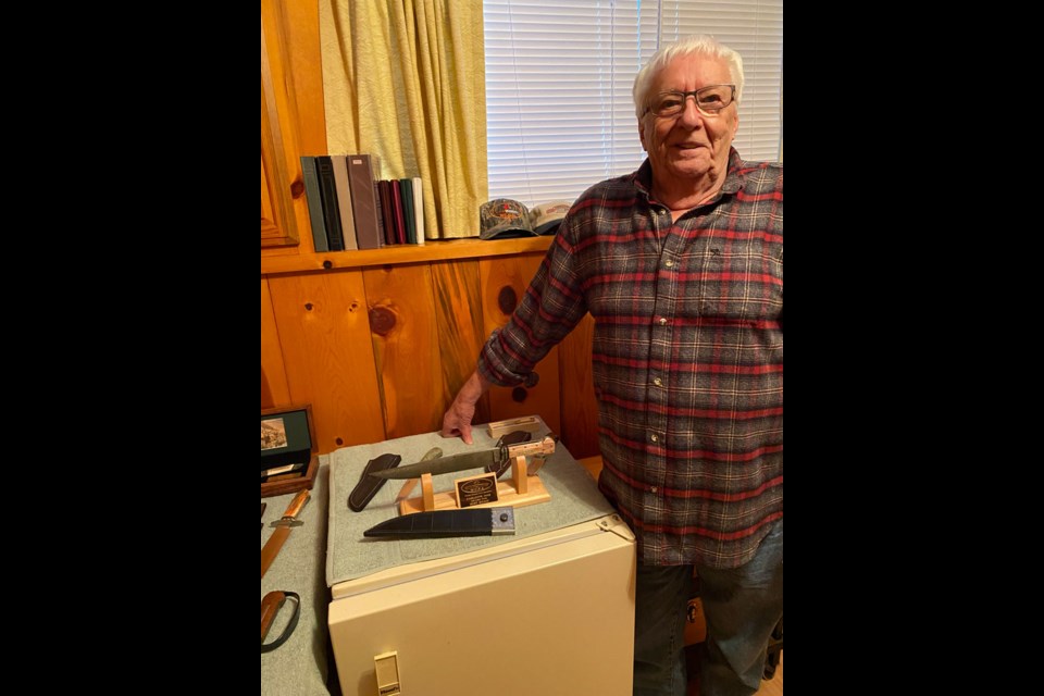 Garth Hindmarch displaying his custom-built knives. 

