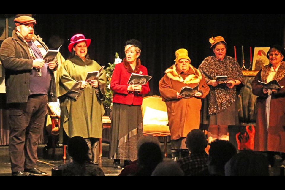 The community carollers opened the play, Gift of the Magj, and sang throughout the production, directed by Colleen Weimer.