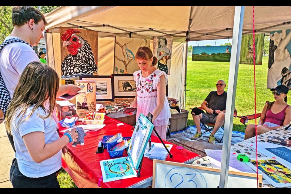 Tara Jaap-Keating, centre, had a booth with paintings, drawings and copies of her books at Weyburn's Gifted summer art market on Saturday.