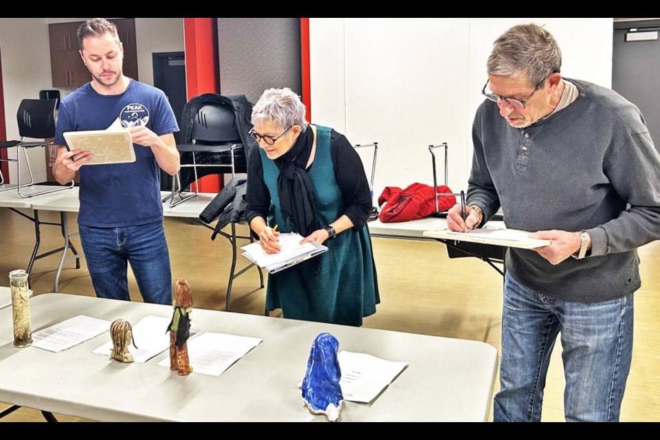 Judges Christopher Borshowa, Marilyn Nelson and Casey Kievits look over entries for the Great Pottery Throwdown recently.