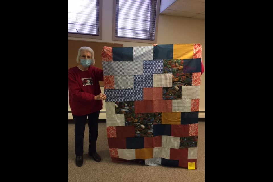 Kamsack Quilting Club member Marjorie Orr was photographed with her quilt called “Garden Wall.”