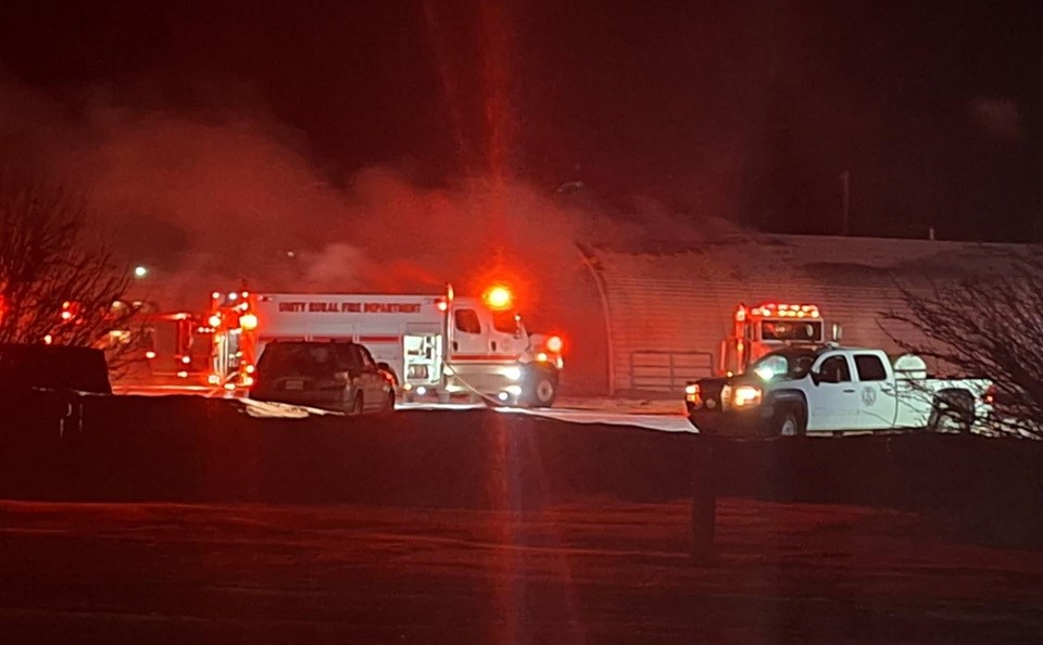 Unity Fire Department and EMS crews fill the parking lot of the Unity Agroplex grounds, as they attempt to extinguish the flames coming from the roof of the building.