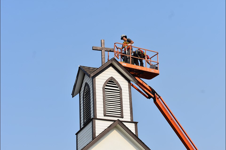 The new cross affixed onto of the steeple in Battleford