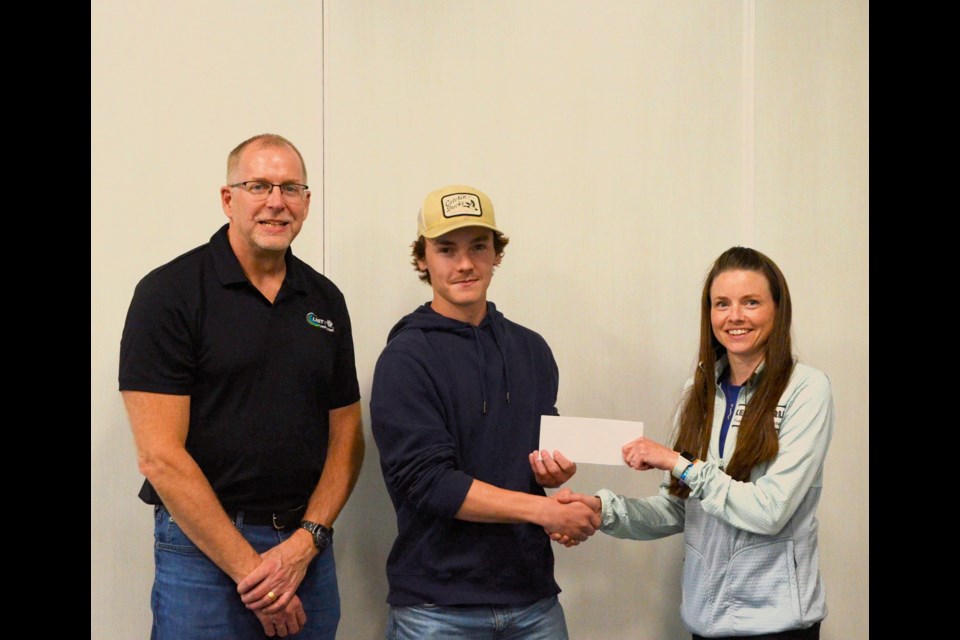 Bronson Volk, centre, and his business Edge Window Washing are welcomed to the Unity business community by Unity Chamber of Commerce member Gerald Hauta, left, and president Kelsey Sperle, right.