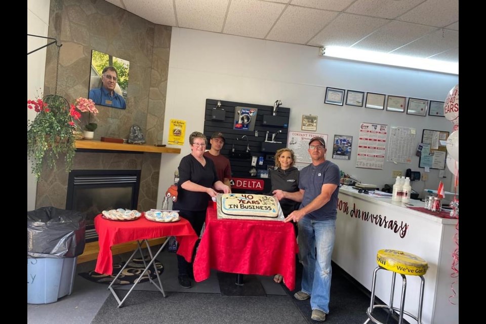 An anniversary cake is cut during the 40th anniversary celebration at C.R. Plumbing. From left are Val Rousseau, Tristin Rousseau, Shelly Rousseau and Tyson Rousseau.