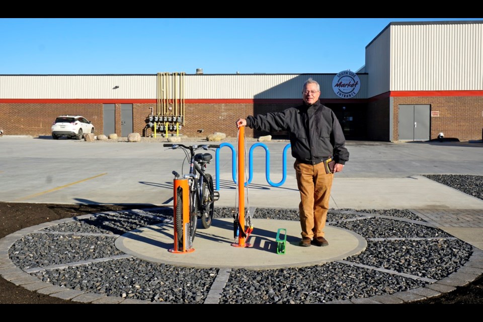 Martin Blair with First Aberdeen Properties Ltd. standing at the brand new bicycle repair station by the Estevan Market Mall.                               