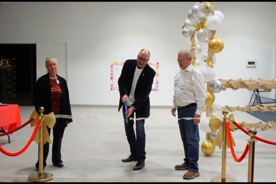 Mayor Roy Ludwig, and Arlene Stebeleski and Martin Blair with Estevan Market Mall, cut the ribbon to mark the end of the major construction of the main entrance and food court.