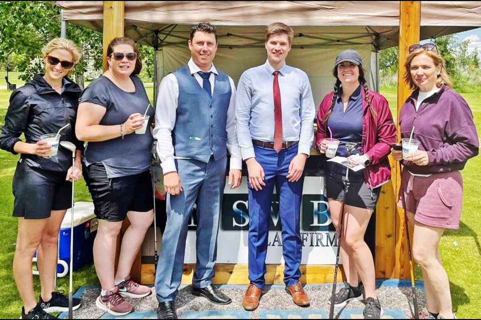 Lawyers Mike Weger and Levi Paradis, centre, introduced their firm’s new name while sponsoring a hole for the Weyburn Oilwomen’s Golf Tournament recently. From left are Jayme Payak, Tina Clay, Jodie Bell and Moria Pulfer. The new name of Weger Paradis Law Firm took effect on July 1.