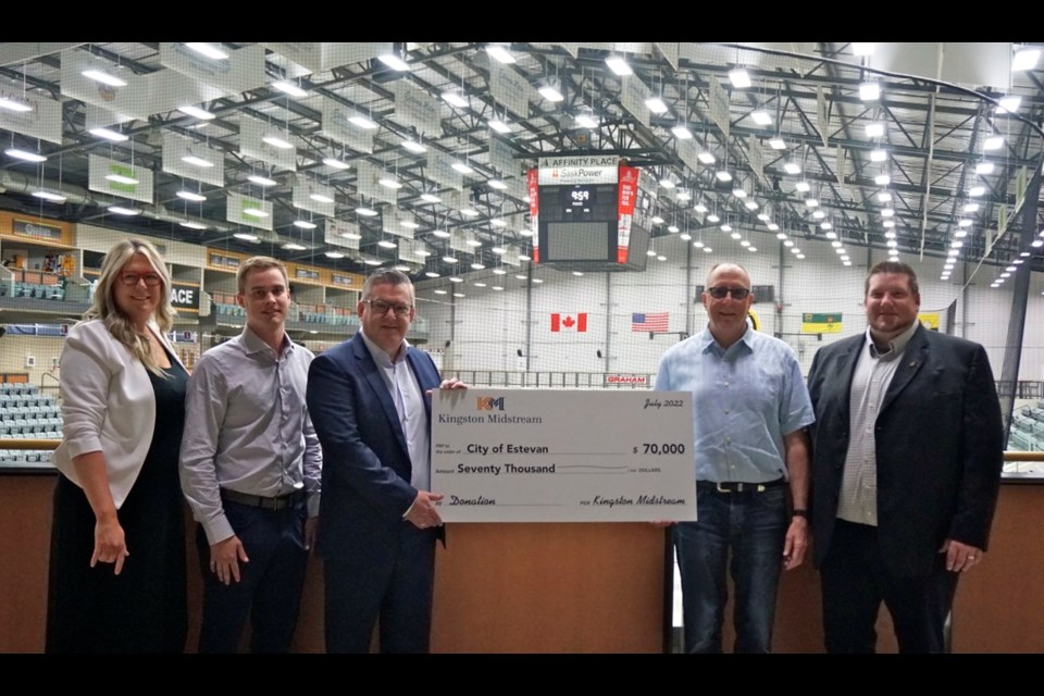 From left, Becky Cassidy, external relations advisor with Kingston Midstream, Michael Hengen, engineer with Kingston Midstream, and Kevin Armstrong, vice president, operations with Kingston Midstream, presented a cheque for $70,000 to go towards the new score clock to Mayor Roy Ludwig and city manager Jeff Ward.                               