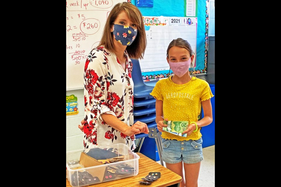 Verna O'Neill of Community Futures Sunrise had a look at the earrings designed by Kamryn Doud of St. Olivier School in Radville, as she is getting ready to enter the YouthBiz contest for students.