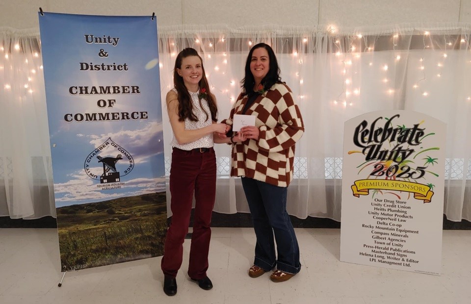 Bank of Montreal manager Shanna Magnus accepts recognition of 115 years of business from Unity Chamber of Commerce president, Kelsey Sperle.