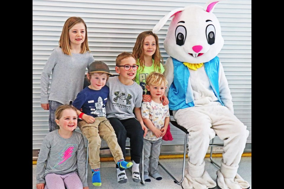 Children from three families gathered with the Easter Bunny, during his surprise last visit on Wednesday. The children include, in the back, Bella, Porter, Lucas and Hudson, and in front are Billy and Boden