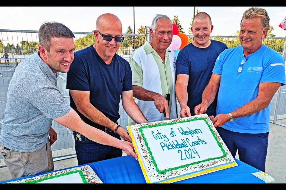 City of Weyburn representatives had a special cake on hand for the opening of the new pickleball courts. From left are Andrew Crowe, leisure services director; Coun. Jeff Richards, Mayor Marcel Roy, facilities director RIchard Henning, and Bob Maurer, president of PIckleball Weyburn.