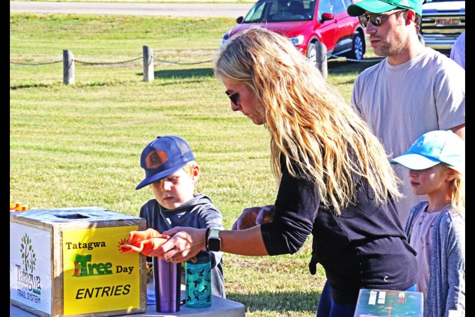 Brooks and Leah Kot put their names in for prize draws, as they attended the Tatagwa Tree-planting day in 2023.