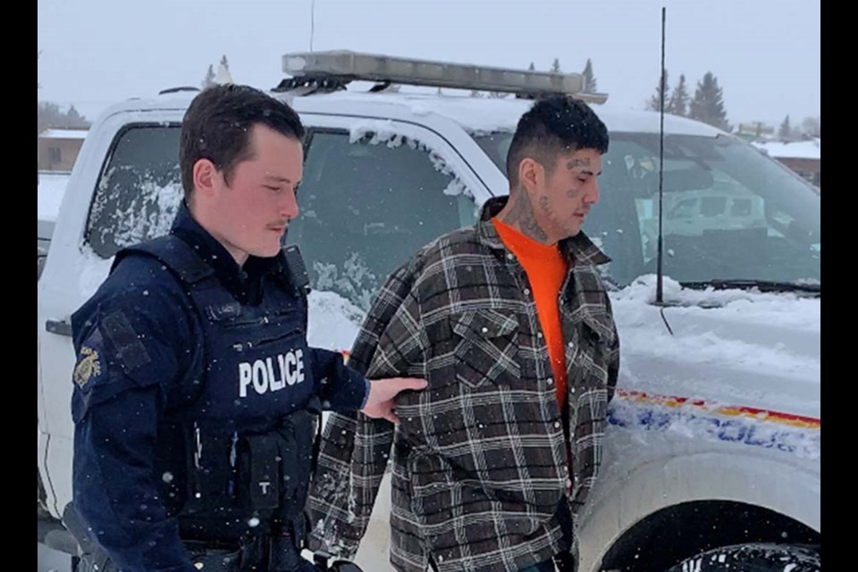 Jonathan Swiftwolfe is escorted into Battleford Court of King's Bench on Feb. 26, 2024. 