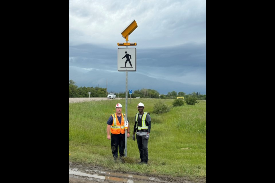 Two employees with Fox Canada were able to install the new signage and lights in between heavy rainfalls.