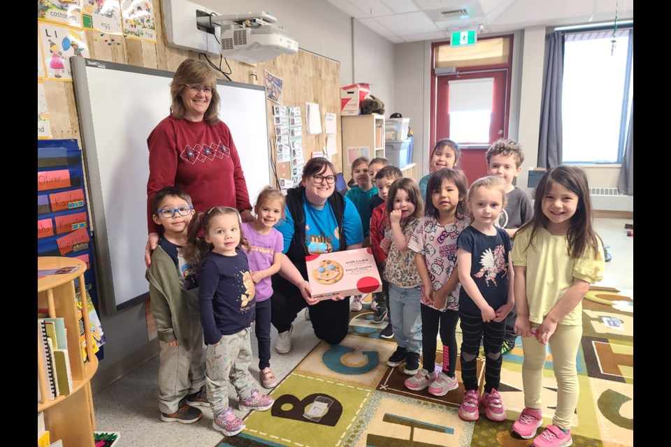 Two LSkySD speech-language pathologists deliver a cookie order to Unity Public School. UPS will be one of the locations to receive a communication board if the fundraising target is met. 