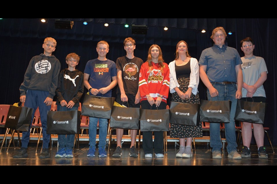 Jeff Bisschop presented the Crossroads Credit Union Student Recognition Awards, from left, to: Ashton Strelioff (Grade 7), Jayden Dergousoff (Grade 5), Chance Weinbender (Grade 6), William Sliva (Grade 8), Josie Mirva (Grade 9), Miah Ruf (Grade 10), Noah Prychak (Grade 11) and Josh Rock (Grade 12).