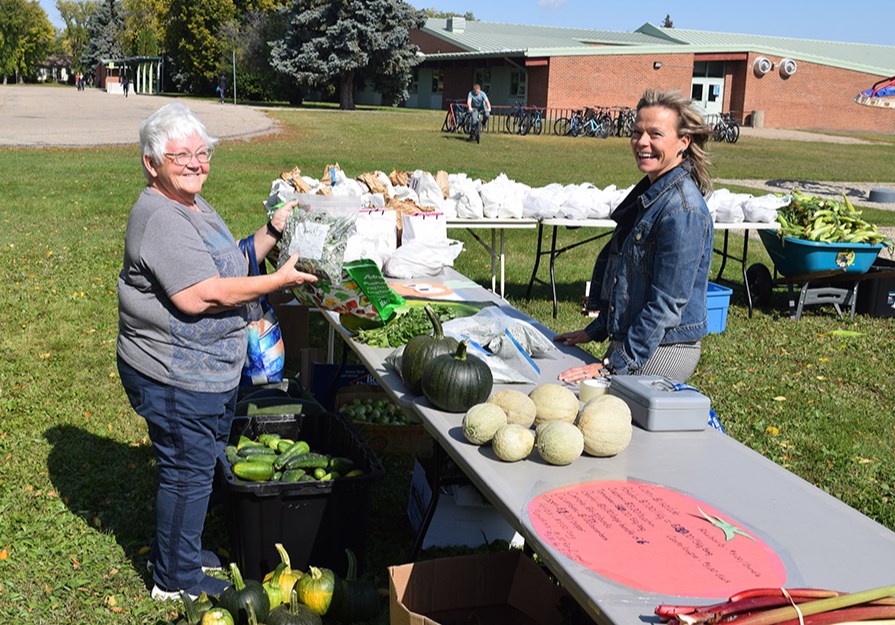 Helen Forbes, left, was one of the first to check in on the Canora Composite School produce sale on Sept. 14, and picked up some basil, corn and beets.