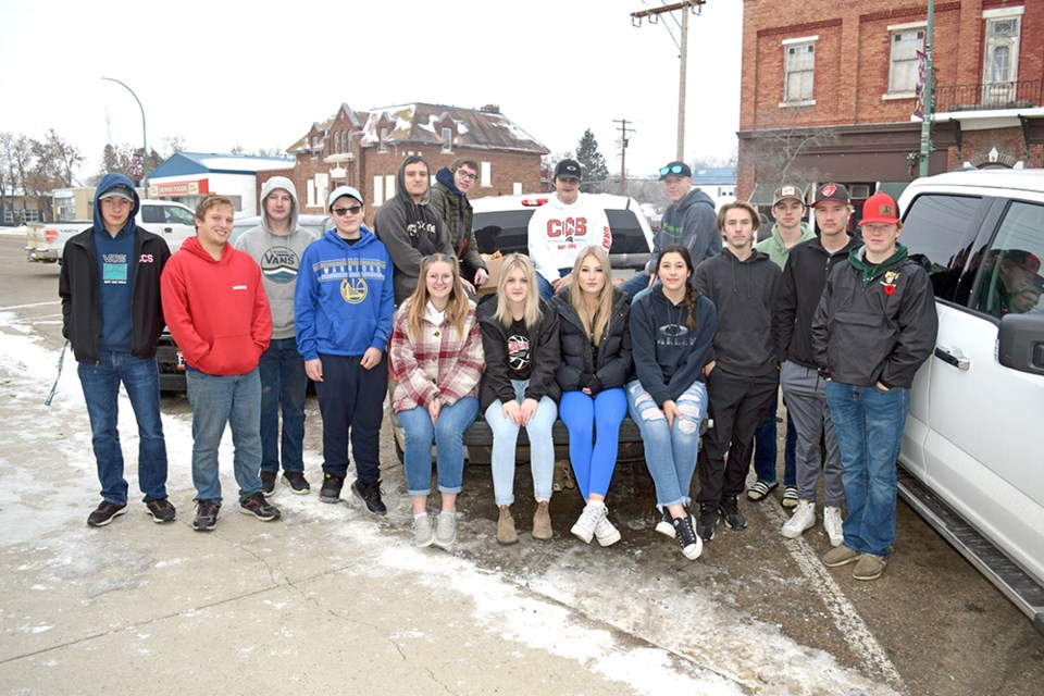 Students at Canora Composite School recently completed their Scare Away Hunger Halloween Food Drive. In the midst of unloading a truck carrying the food at Filling The Gap Food Bank, the hardworking students stopped for a photo. From left, were: (back row) Bronson Heshka, Brandon Harder, Owen Borson, Josh Rock, Kaulen Katryniuk, Aidan Ash, Ethan Curtis, Ty Baillie, Brayden Goetzinger, Lucas Latham, Nate Wolos, and Porter Wolkowski; and (seated on tailgate) Callie Sznerch, Jordan Harper, Shayna Leson, and Bailee Zuravloff.  