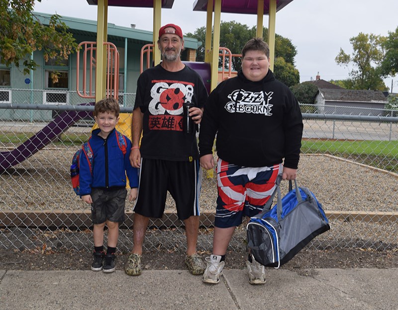 Kelton Fehr, left, was all set to start Grade 1, with the support of his big brother Jasper, right, who is in Grade 4 and has lots of experience at CJES. They were joined for the photo by their dad, Chuck Fehr.