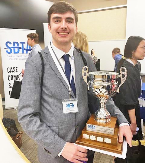 Dalton Molnar shows the trophy he won at the SBTA case competition earlier this year.