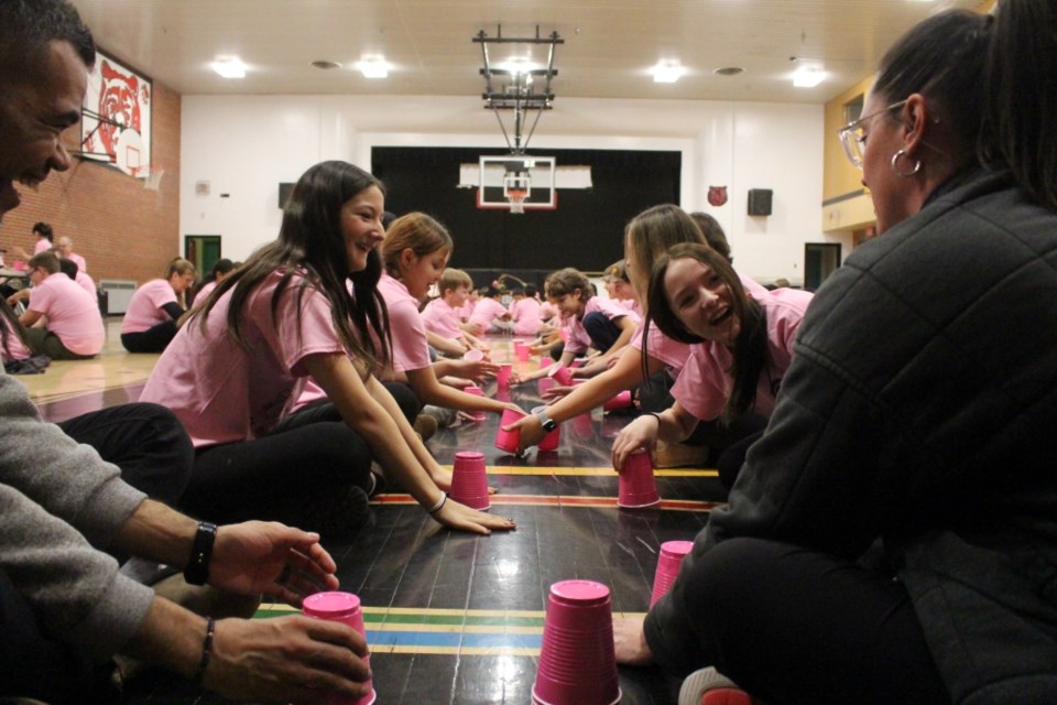 Students used plastic cups as instruments for the Be Kind Rhythm Project.