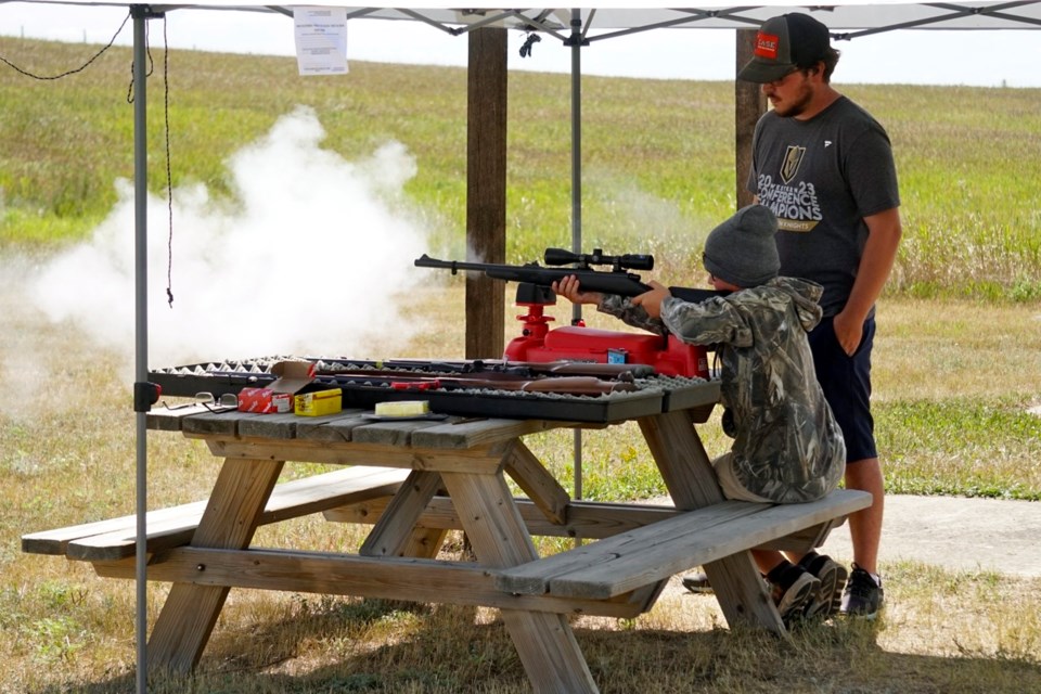 Cale Porter shot muzzleloader at a target under supervision of Adam Cowan. 