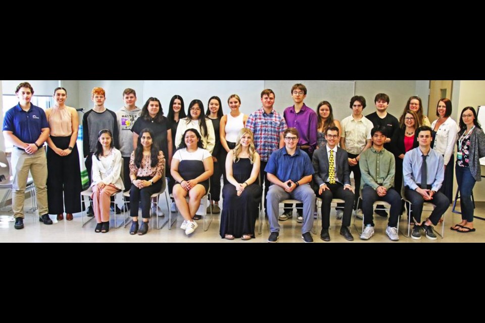 Standing, left to right, are Ben Michel, mentor, Post-Secondary Finance Summer Student, Harbourfront Wealth Management; summer Business Finance student Olivia Michel, Mentor, accountant, Grant Thornton LLP; Cris Shipley, Ryder Goertzen, Emily Edwards, Bailey Burnett, Kelsie Arthur, Ashton Sanguin, Maximum Kilback, Zailey Milewicz, Jayden Stang, Conner Bildstein; Lynda Rideout, Executive Director, Envision Counselling & Support Centre; Monica Osborn, Mentor, Executive Director, Weyburn Chamber of Commerce; Raven Daer, Communications Specialist, Envision Counselling & Support Centre; Standing, middle row, left to right, Acacia Wanner, Yuan Presto, and Margot Arnold, WCS Business Education Teacher. Sitting in the front row, left to right, Harriet Segaya, Anushka Raulji, Jof Regidor, co-presidents Kaitlin Demchynski and Owen Klein; Jonas Burdan, Emmanuel Pallarca and Max Crane.