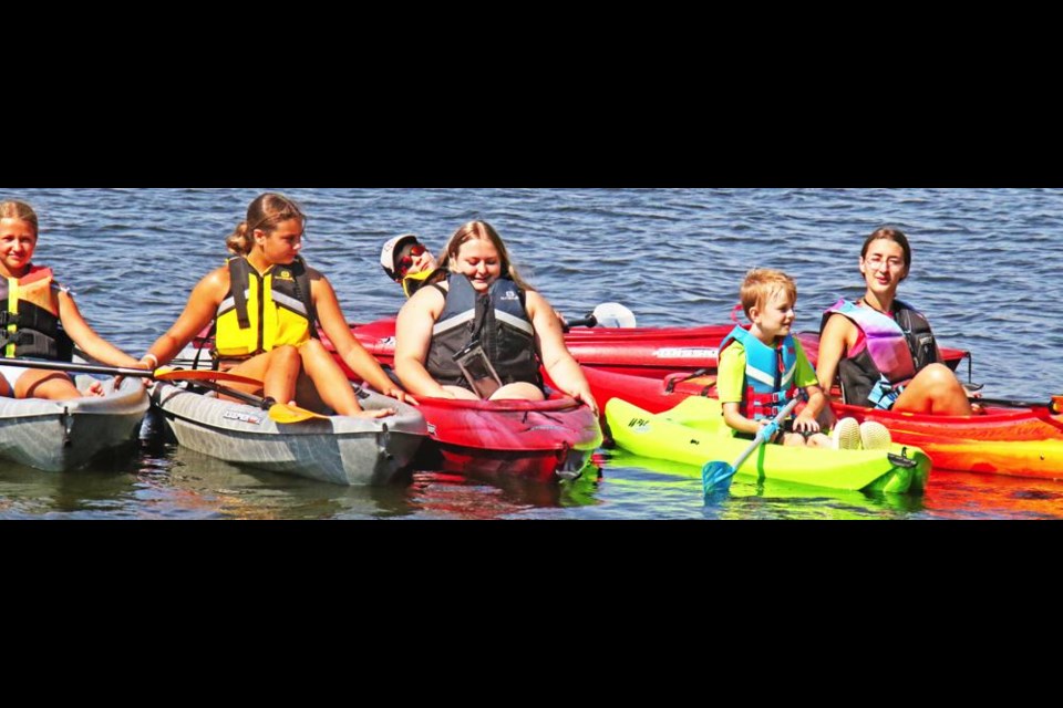 Some of the teachers and students in the summer kayak camp joined boats together for a photo on Friday morning on Nickle Lake.