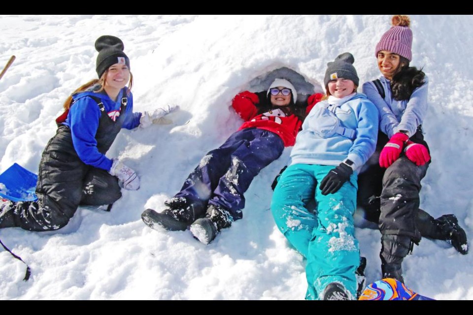 Grade 7 students Kenzie M., Ale R., Hailey C. and Deeshika R. had a rest after building a quinzee in Jubilee Park on Friday, as a "Tiger Time Out" activity at St. Michael School.