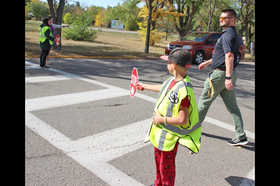 A student acts as a safety patroller.