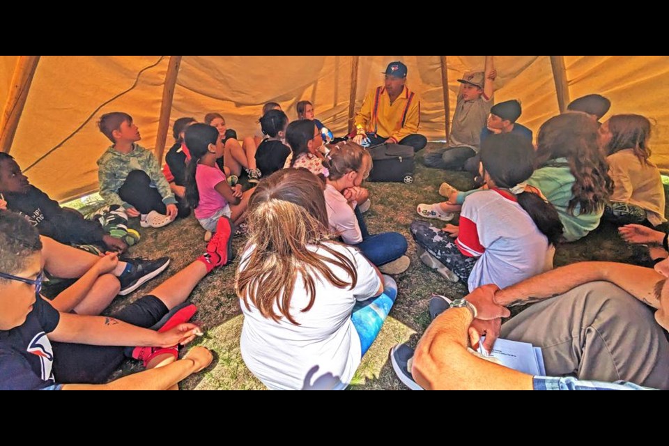 Knowledge keeper Lyndon Linklater shared stories and traditions with a Grade 5 class, inside a tipi he had set up on the grounds of St. Michael School on May 28.
