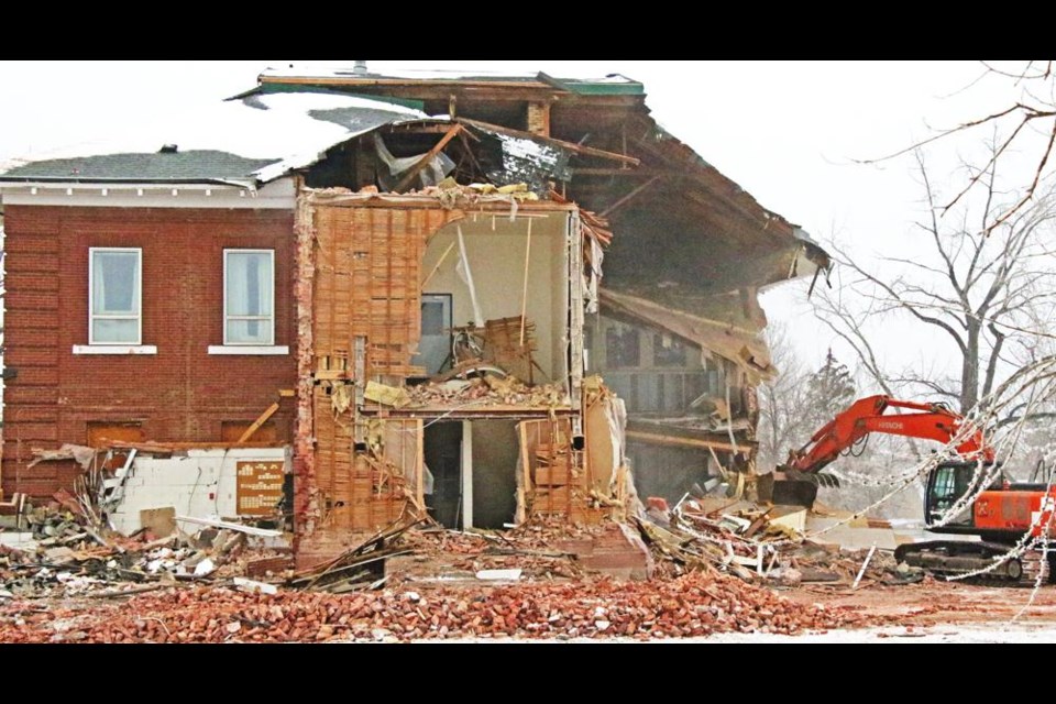 The demolition of Souris School, which has stood since 1910, began over the weekend, and is shown here on Monday morning as a power shovel took the building down.