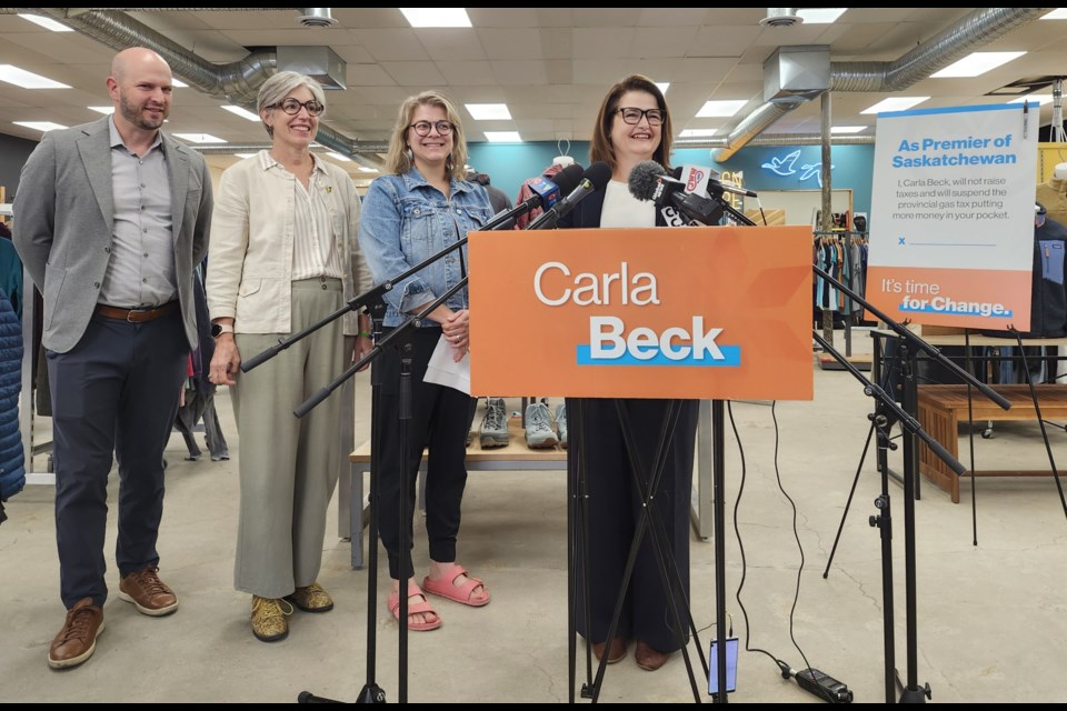 Sask-NDP Leader Carla Beck, third left, announces her party's tax plans if they earn the majority in the election. MLA's Matt Love (Saskatoon Eastview), Erika Ritchie (Saskatoon Nutana), and small business owner Nancy are others in the photo.  