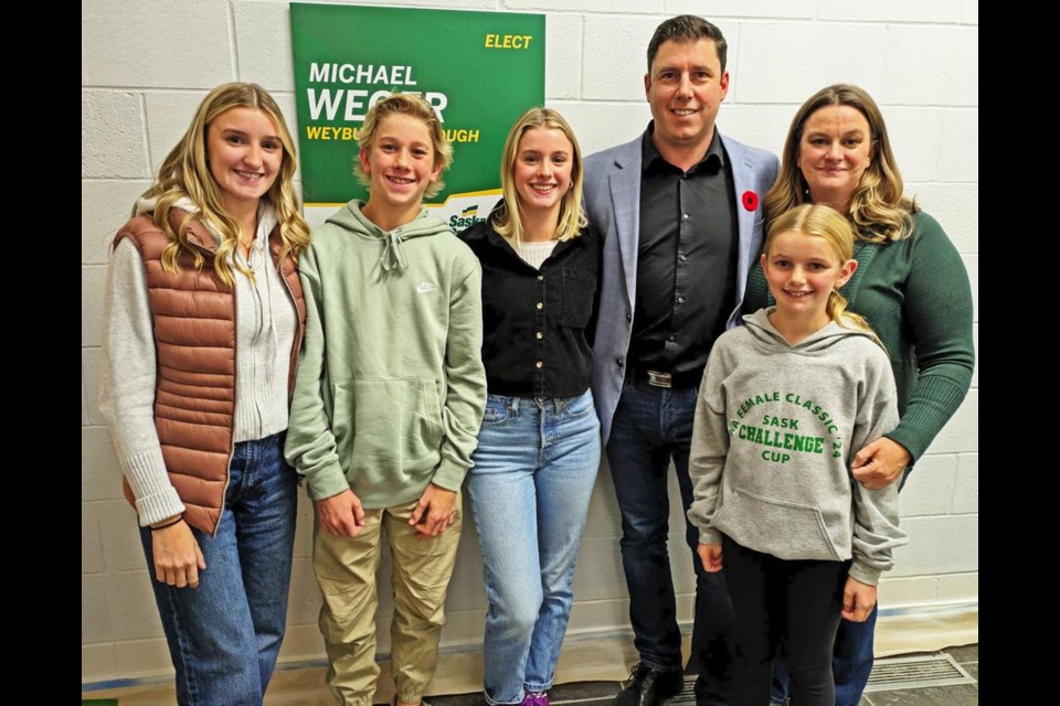 Weyburn-Bengough's first MLA, MIke Weger, gathered with his family while watching results with supporters at McKenna Hall in Weyburn on Monday night. From left are Teresa, Bennett, Meaghan, Mike and Cara Weger with daughter Abigail in front.