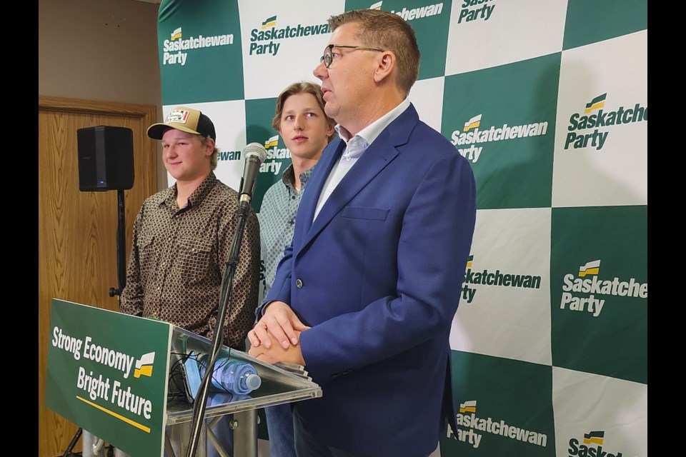 Jake Glubis, from left, and his brother Luke joined Saskatchewan Party Leader Scott Moe on Wednesday, Oct. 2, during the announcement of increasing the Graduate Retention Program. 